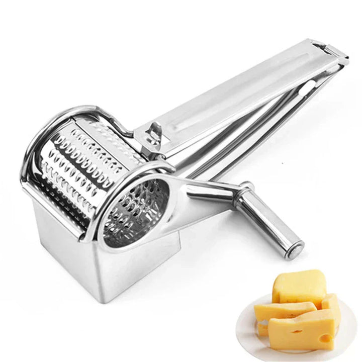 Home cook using a stainless steel manual rotary grater to grate fresh cheese over pasta.