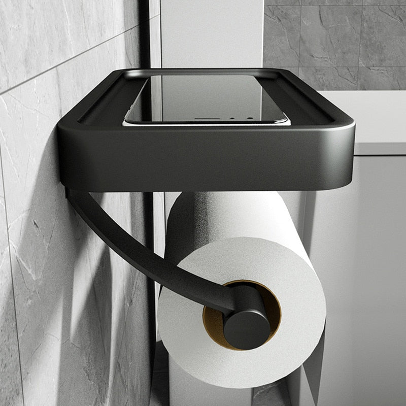 Sleek stainless steel toilet paper dispenser with integrated shelf for bathroom essentials.