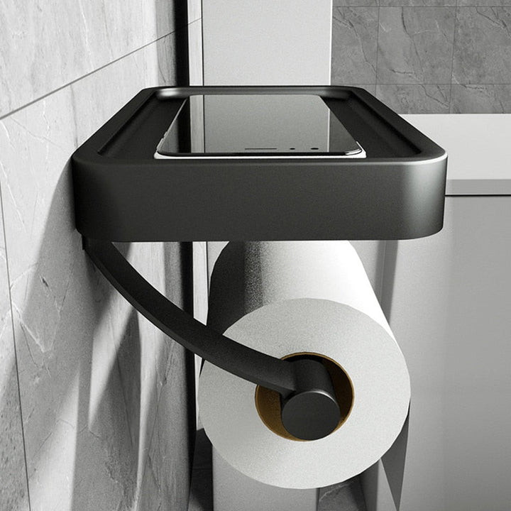 Sleek stainless steel toilet paper dispenser with integrated shelf for bathroom essentials.