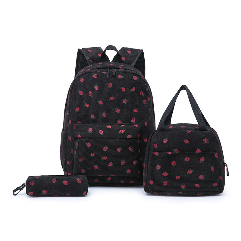 Close-up of vibrant pink strawberry pattern on a youth school backpack, stylish & functional.