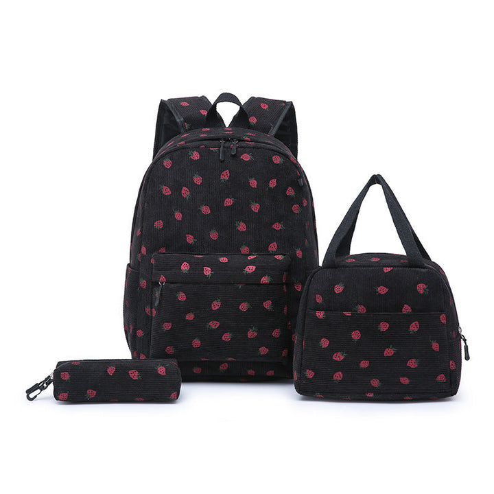 Close-up of vibrant pink strawberry pattern on a youth school backpack, stylish & functional.