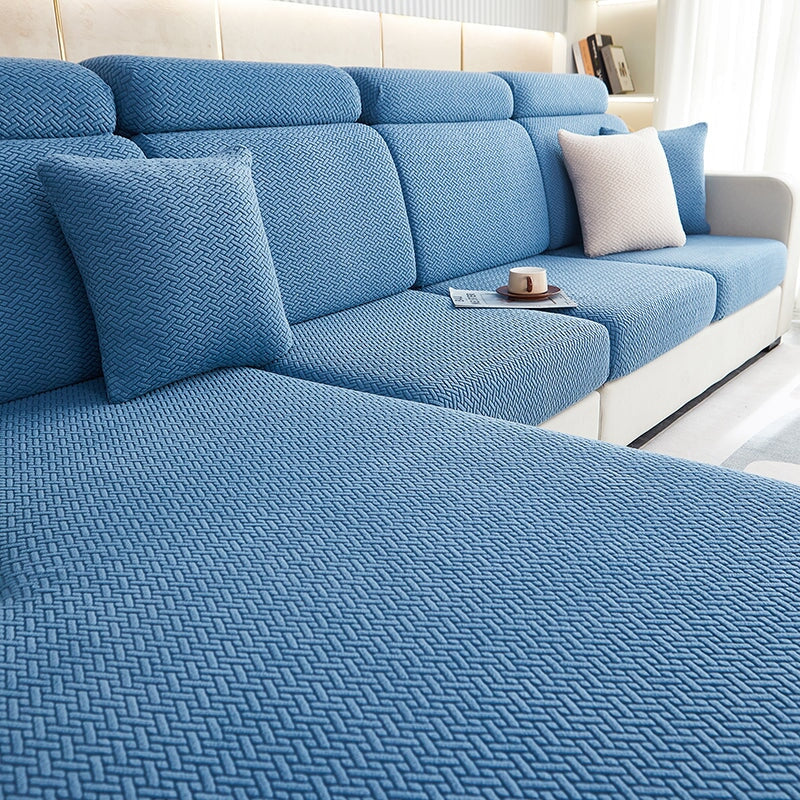 Stylish stretchable sofa cover in navy blue, enhancing living room decor with a snug fit.