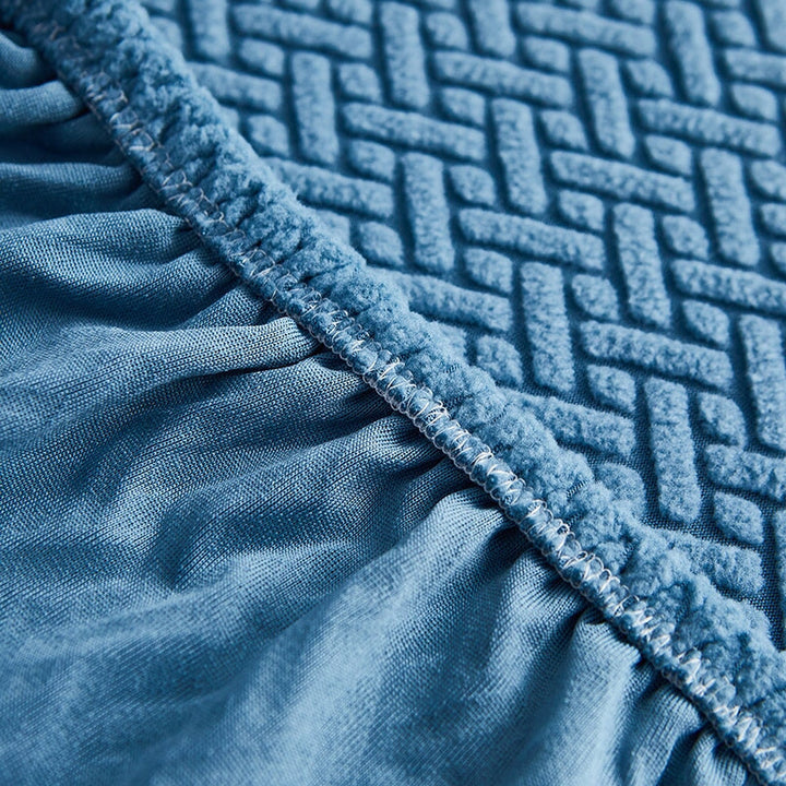 Cream stretchable furniture cover for sectional sofas, offering protection & a fresh look.