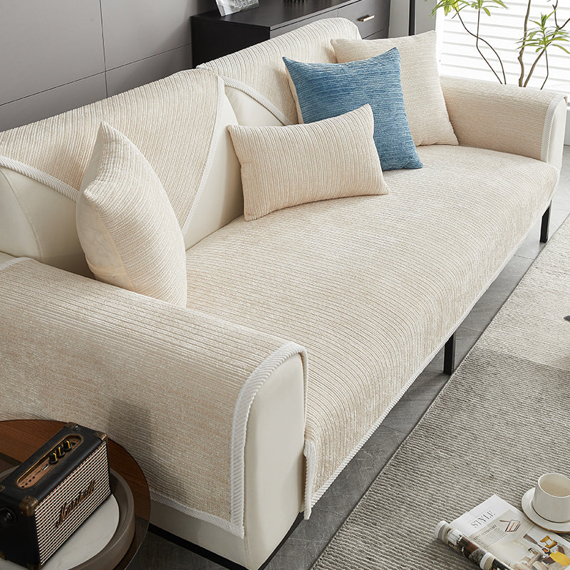 Striped chenille sofa cover, pet-friendly & anti-scratch, protecting modern living room furniture.