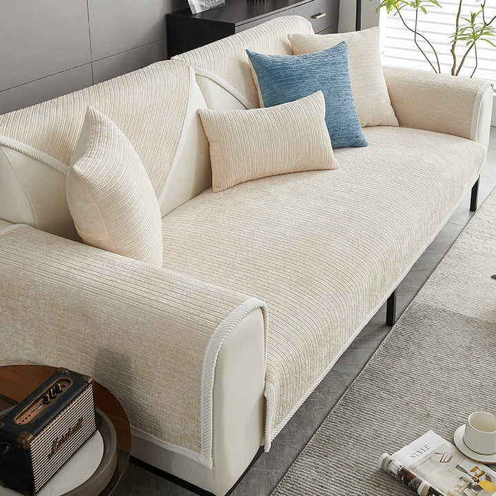 Striped chenille sofa cover, pet-friendly & anti-scratch, protecting modern living room furniture.