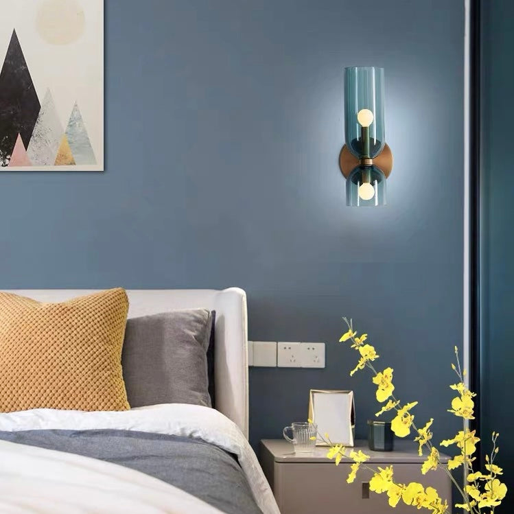 Chic glass twin wall lamp, features dual shades for a sophisticated, modern lighting look.