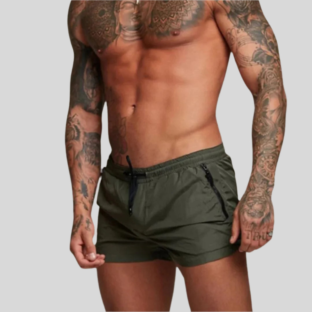 Comfortable men's quick-dry swim trunks, ideal for beachwear, poolside lounging & athletic swimming.