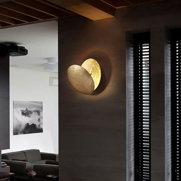 Modern Scandinavian living room wall sconce. Round LED lamp providing warm light, ideal for contemporary homes.