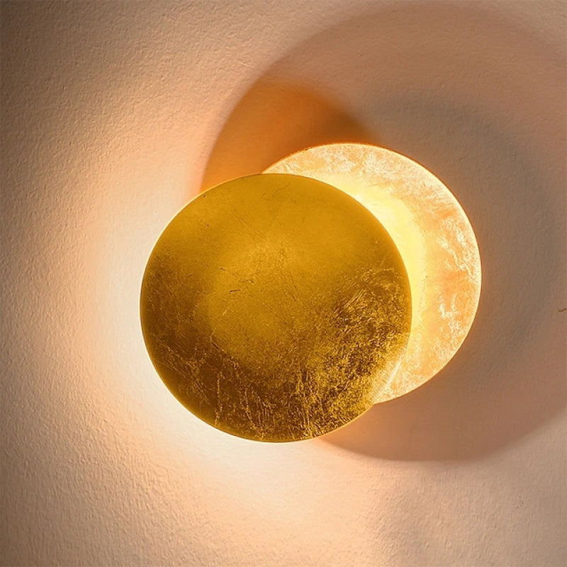 Contemporary indoor wall lamp, round metal design. Features warm white LED light for stylish home decor.