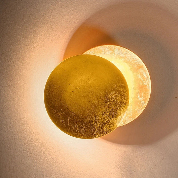 Contemporary indoor wall lamp, round metal design. Features warm white LED light for stylish home decor.