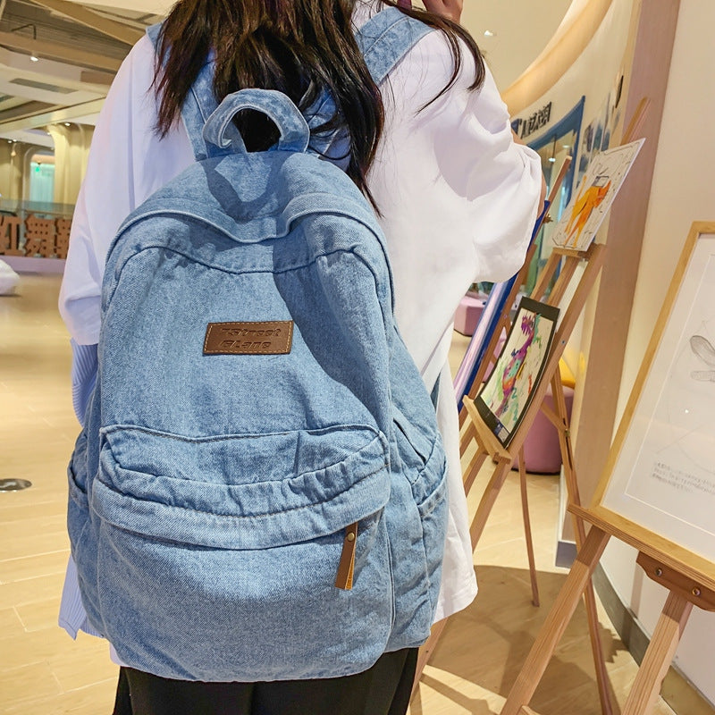 Student's durable unisex denim backpack, great for school books and travel essentials, a versatile everyday bag.