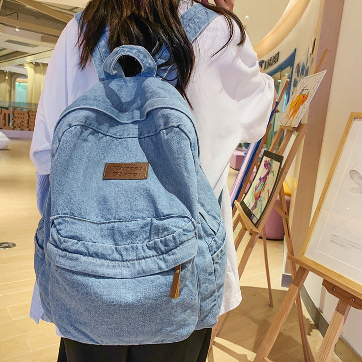 Student's durable unisex denim backpack, great for school books and travel essentials, a versatile everyday bag.