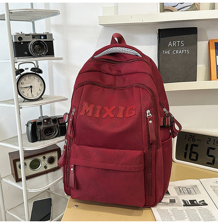 Modern graphic print unisex travel bag & school backpack, multi-pocket design, durable and functional daypack.