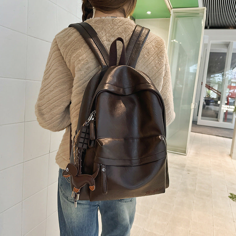Durable leather travel backpack with adjustable straps & spacious storage for daily essentials. Unisex fashion.