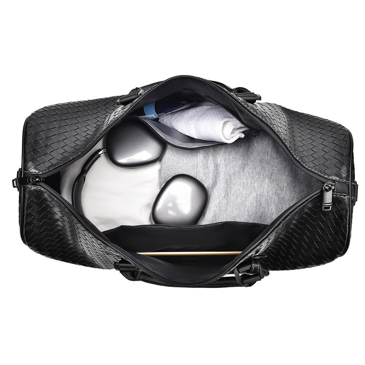 Chic unisex woven leather duffle bag for stylish weekend getaways. A perfect travel companion.