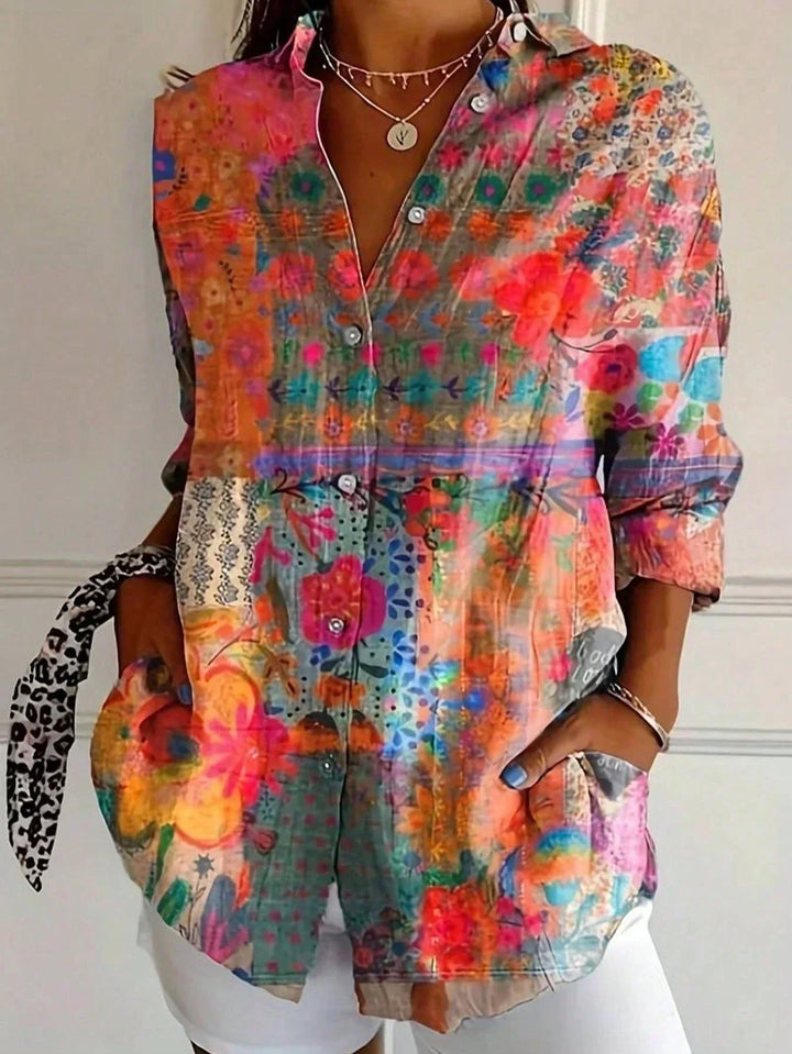 Colorful women's fashion top, an abstract print blouse with long sleeves and a sophisticated button front.