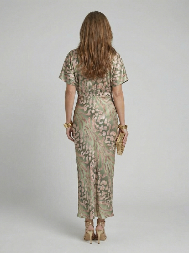 Versatile women's short sleeve midi dress in a vibrant abstract print, designed with a trendy V-neck and twist waist detail.