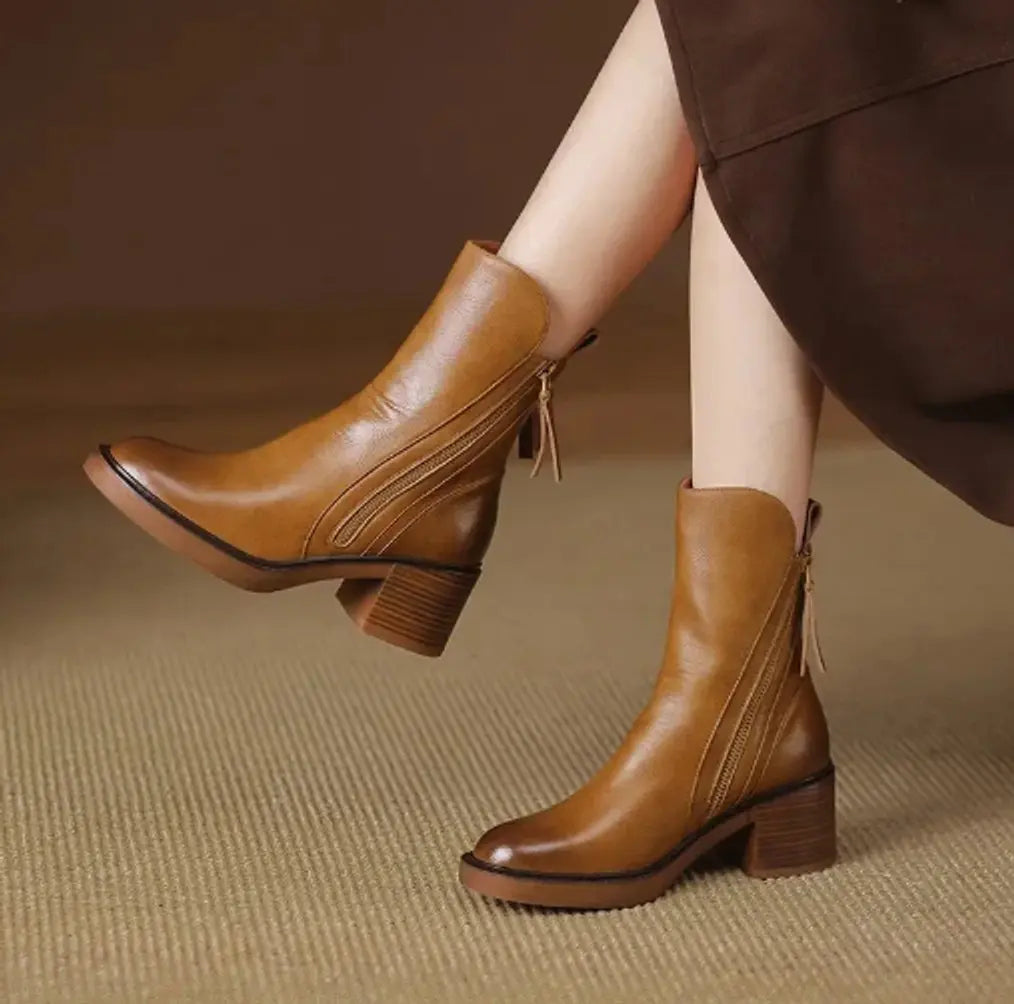 Stylish women's black leather ankle boots with block heel & convenient side-zip closure for fall/winter fashion.
