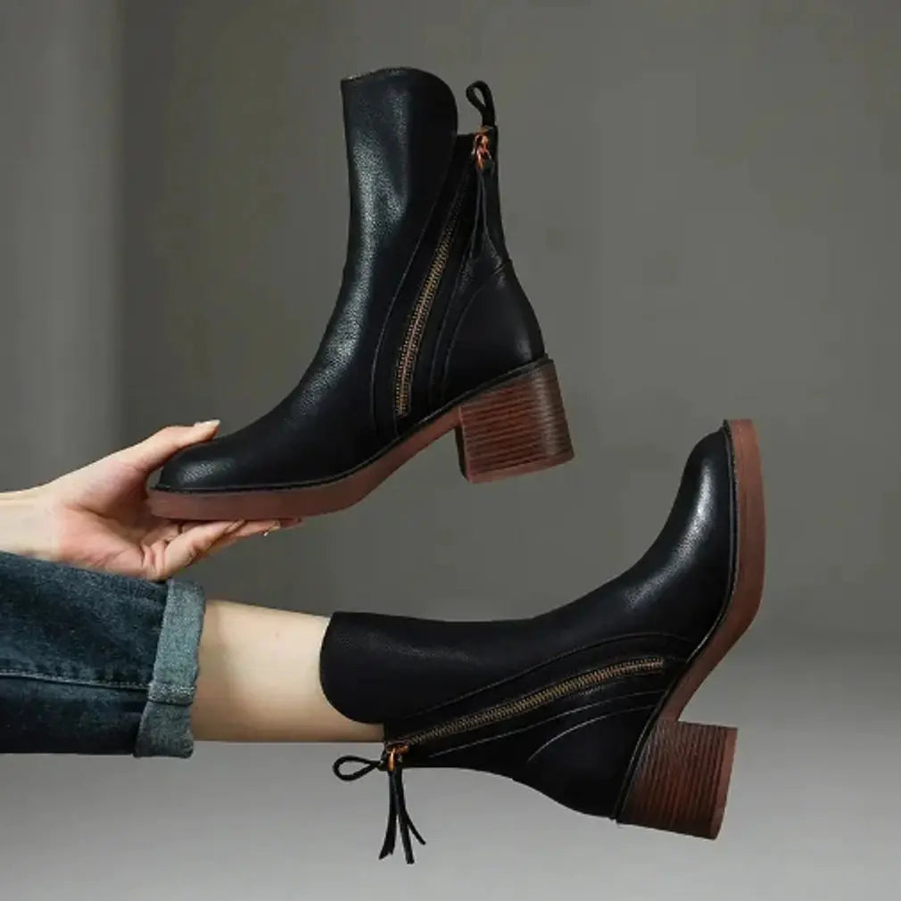 Classic black leather block-heel ankle boots for women. Side-zip closure, a perfect stylish addition for fall & winter.