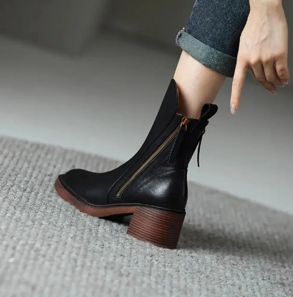 Women's sleek leather ankle boots with a sturdy block heel and practical side zip, suitable for all-day wear.