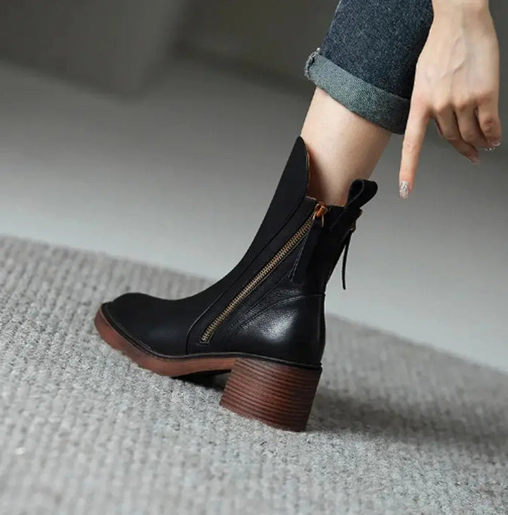 Women's sleek leather ankle boots with a sturdy block heel and practical side zip, suitable for all-day wear.