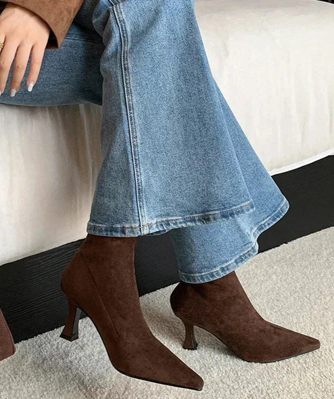Chic women's brown pointed toe heeled ankle boots. Everyday comfort, stylish mid-heel design.