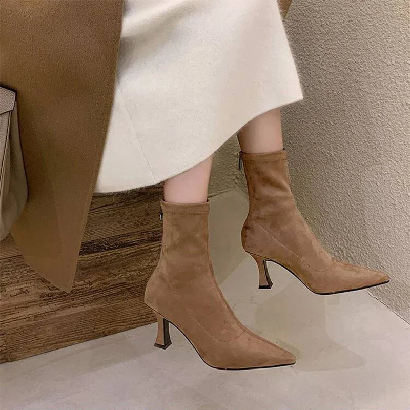 Side view of stylish women's brown pointed toe heeled ankle boots. Mid-heel for versatile everyday wear.