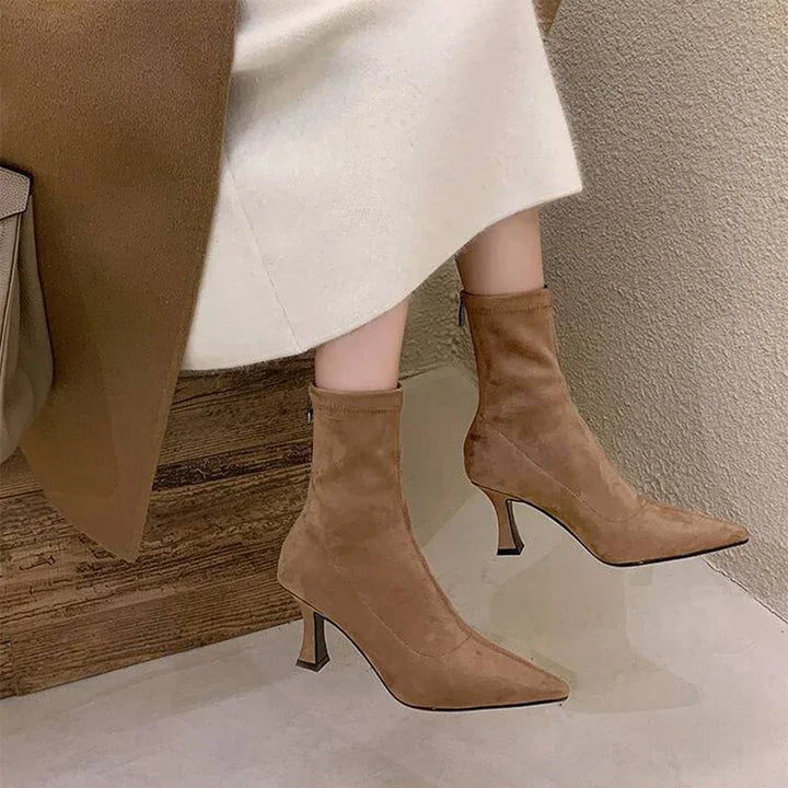 Side view of stylish women's brown pointed toe heeled ankle boots. Mid-heel for versatile everyday wear.
