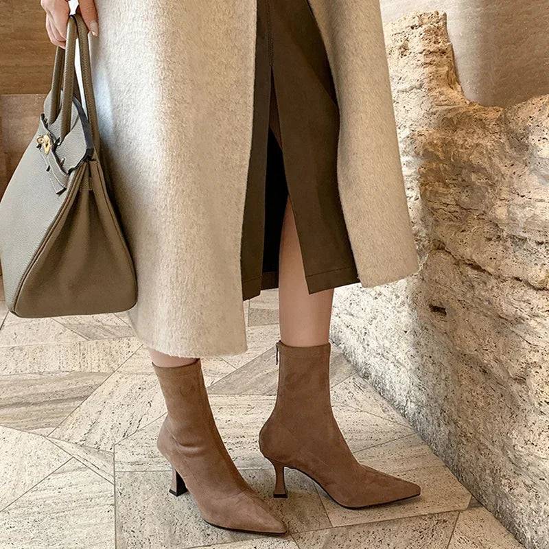 Full view of chic women's black pointed toe heeled ankle boots. Comfortable mid-heel, perfect for everyday style.