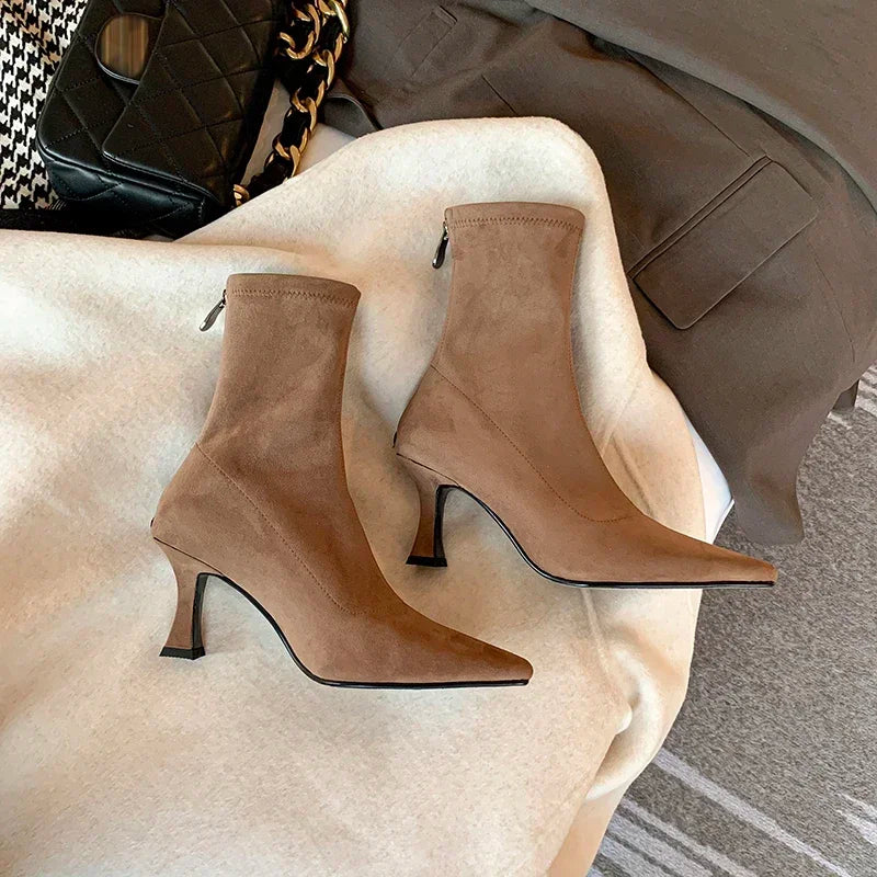 Detail shot: comfortable mid-heel on versatile women's pointed toe ankle boots. Stylish & chic.