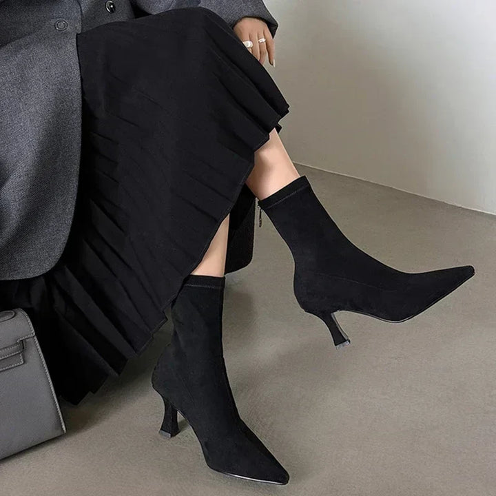 Women's black pointed toe heeled ankle boots. Stylish mid-heel design for comfortable, chic everyday outfits.