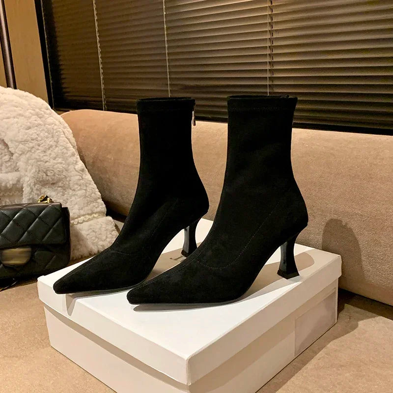 Elegant women's pointed toe heeled ankle boots. Comfortable mid-heel, versatile brown style for everyday wear.
