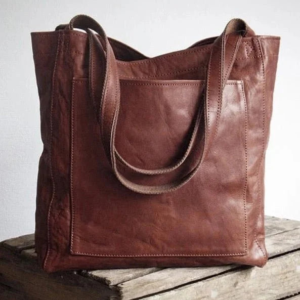Versatile women's black leather shoulder bag with magnetic closure, a chic fashion accessory for daily use.