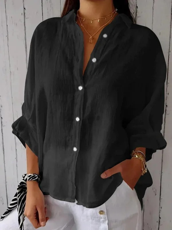Model wears a stylish women's button-up shirt, long sleeve, relaxed fit, perfect for casual elegance.