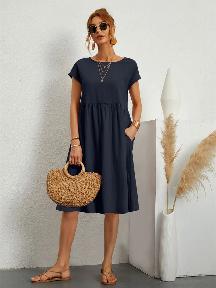 Woman enjoying a comfortable day in a stylish casual midi dress with pockets, versatile everyday fashion.