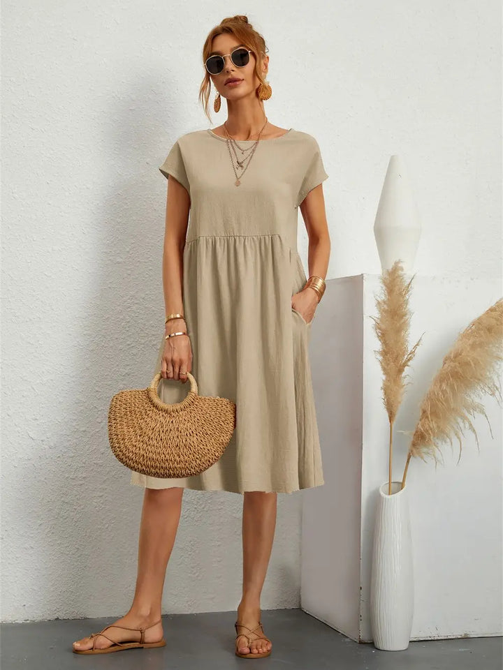 Back view of a relaxed women's casual midi dress, comfortable & stylish for everyday activities.