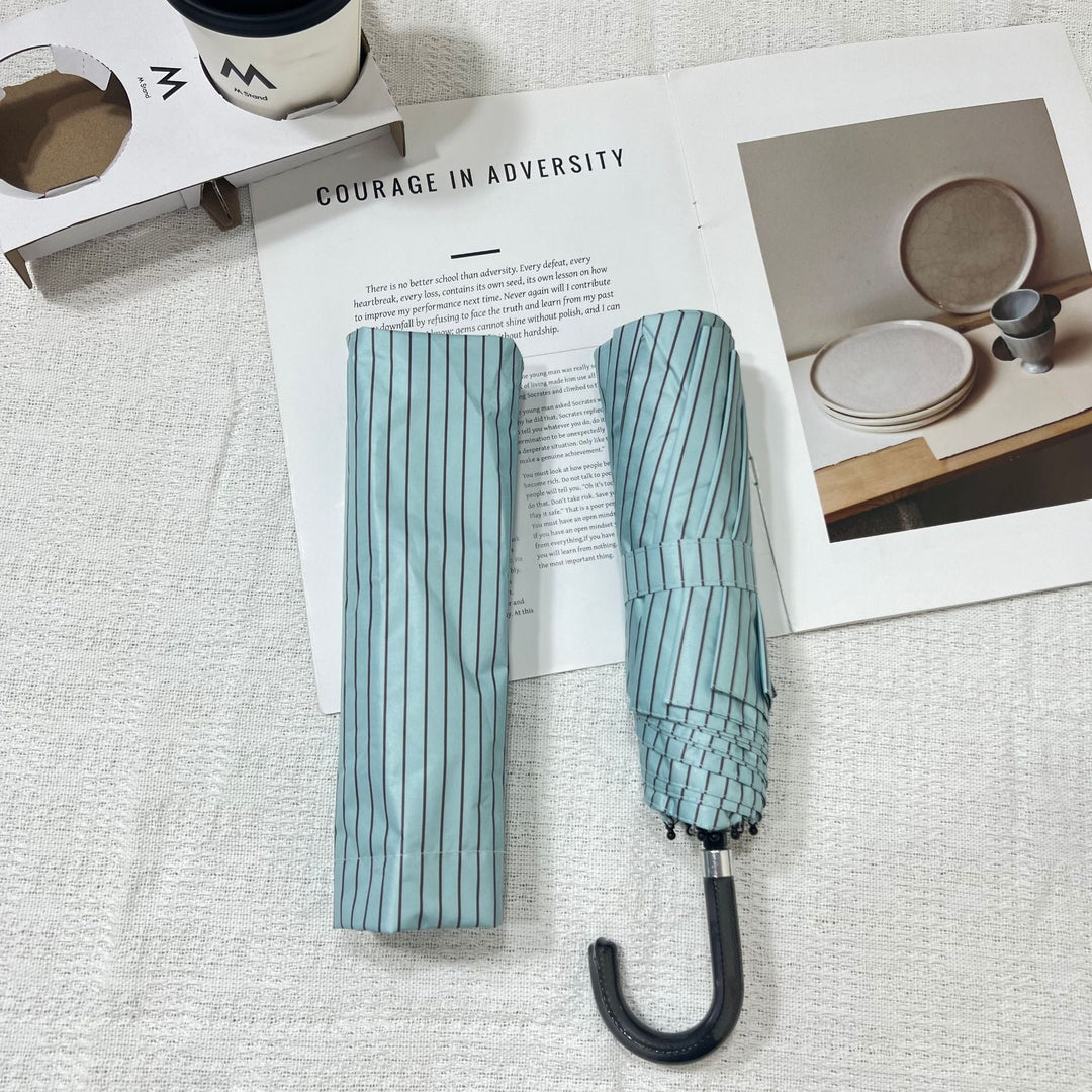 Women's portable rain umbrella, small folding design fits any bag.