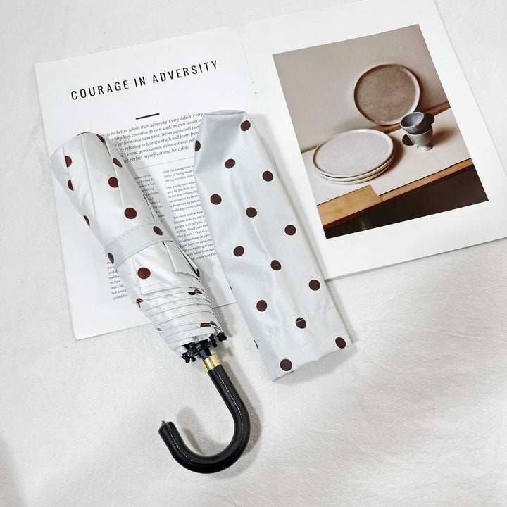 Durable compact umbrella for women, excellent for sudden rain, travel-friendly.