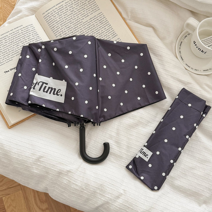 Easy-carry compact umbrella for women, essential rain protection & weather gear.