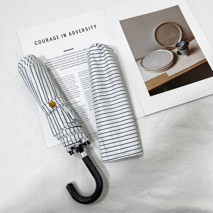 Women's travel-size folding umbrella, waterproof and stylish for any outfit.