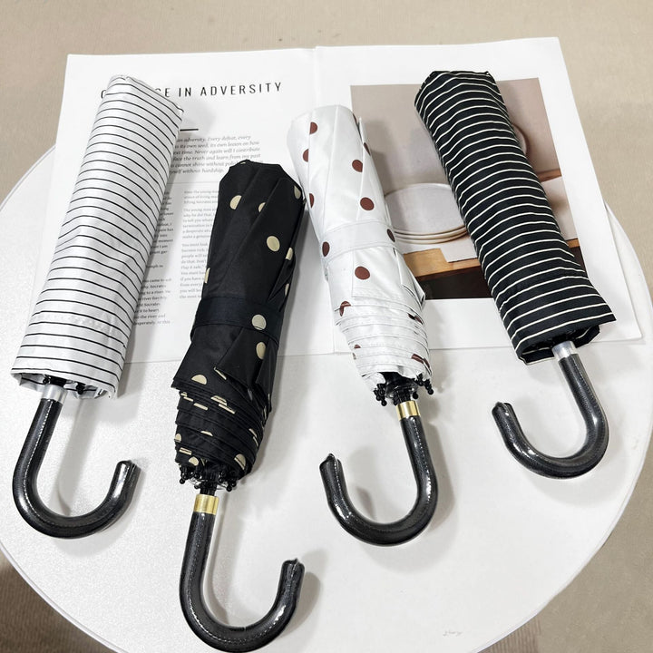Lightweight women's umbrella, compact design for easy rain protection.