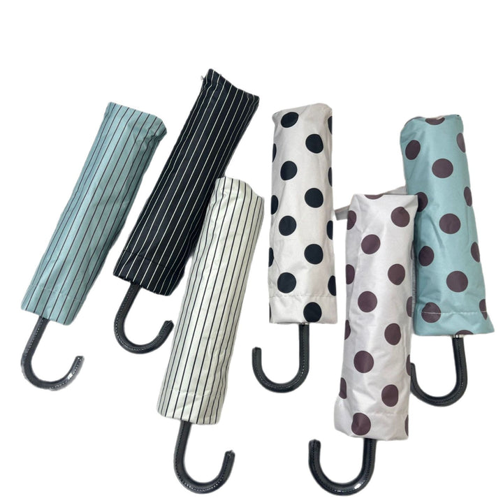 Stylish women's folding umbrella, compact for handbag, reliable rain shield.
