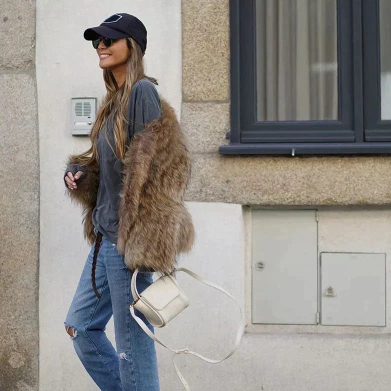 Modern women's cropped winter jacket, a stylish outerwear piece for contemporary fashion and versatile winter styling.