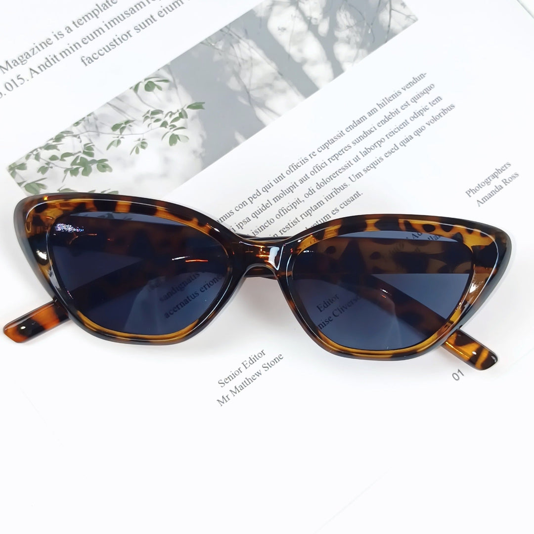 Lightweight women's designer sunglasses, stylish angled frame, essential UV protection.
