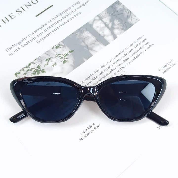 Modern women's designer eyewear, stylish angled frame, provides complete UV protection.