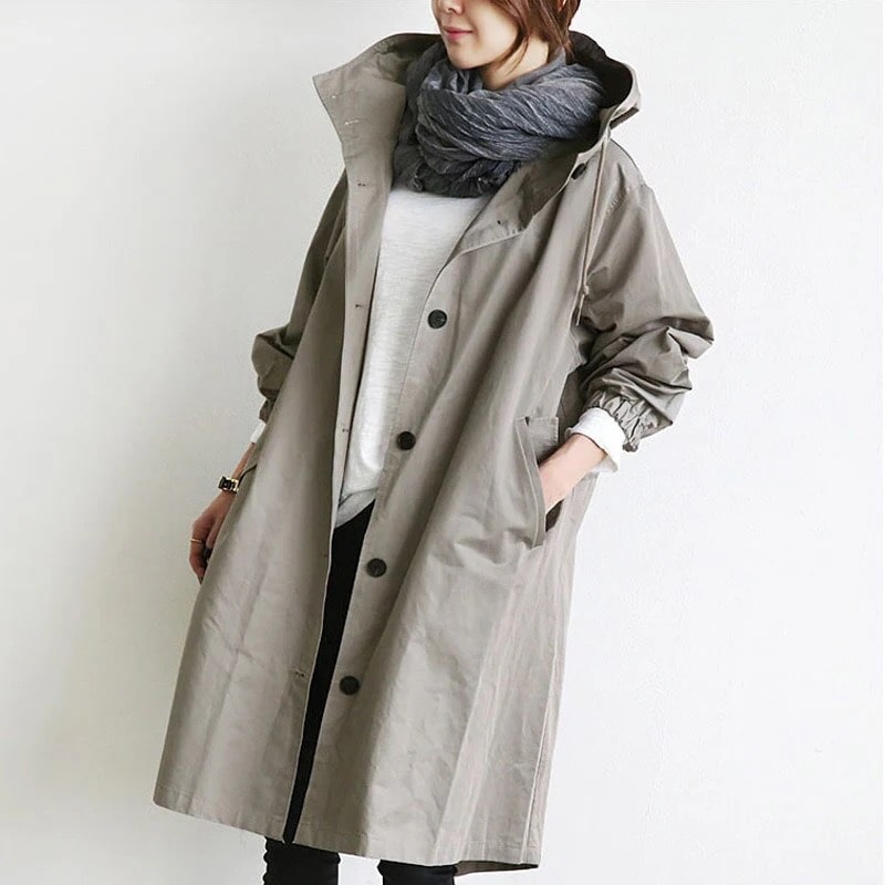 Stylish women's hooded long A-line rain jacket for all-weather protection, lightweight & weatherproof.