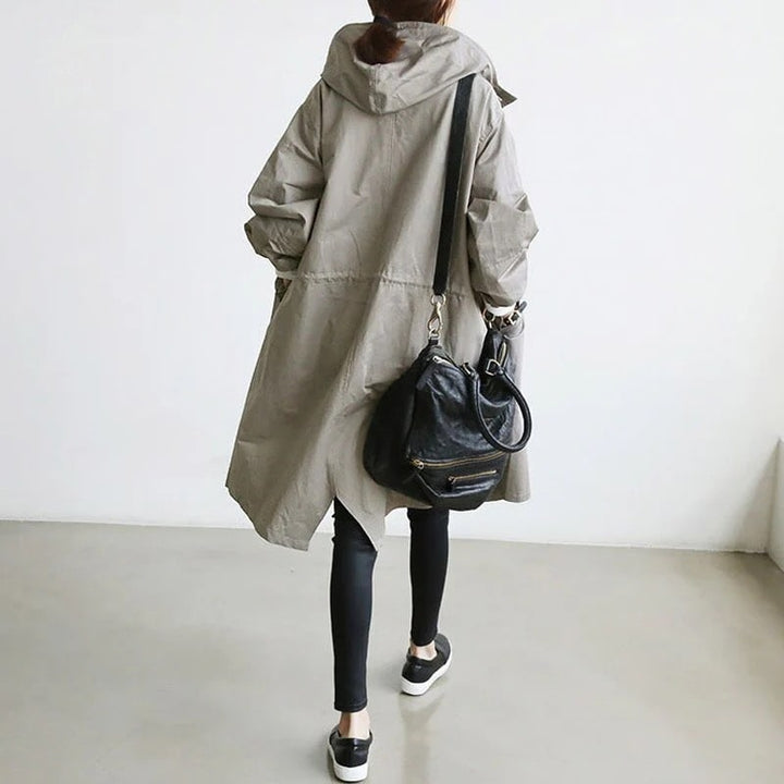Women's long A-line rain jacket, back view, stylish and weatherproof for spring and fall outerwear.