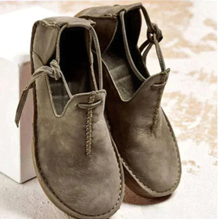 Elegant women's lace-up flats featuring a classic round toe, offering both style and everyday comfort.