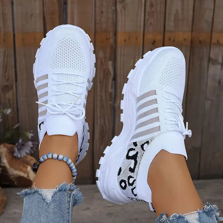 Stylish women's lace-up sneakers with unique textured upper and durable lug sole, perfect for everyday wear.