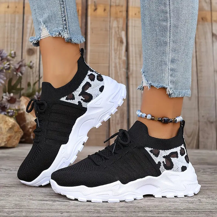 Versatile women's casual footwear: lace-up sneakers with a distinctive textured design and sturdy lug sole.
